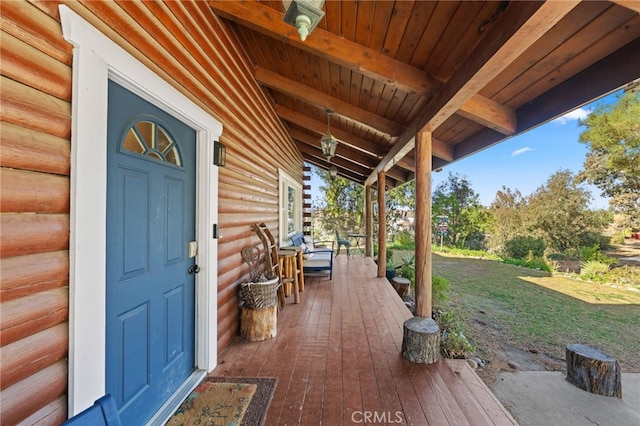 exterior space with covered porch and a lawn