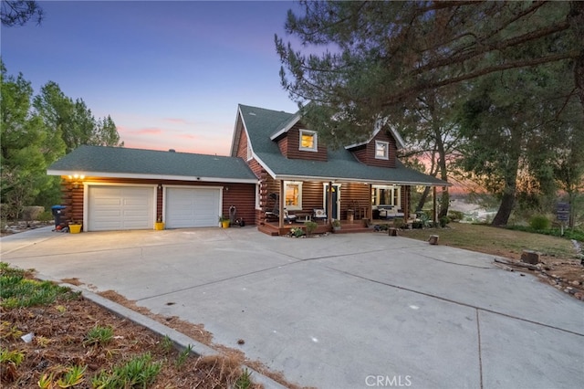 view of front of house featuring a porch and a garage