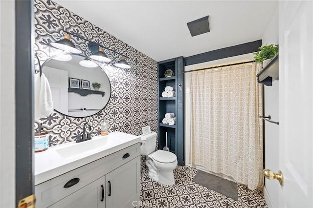 bathroom with toilet, vanity, and a shower with shower curtain