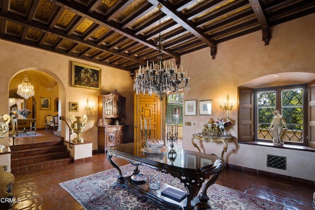 dining area featuring beamed ceiling, a high ceiling, and coffered ceiling