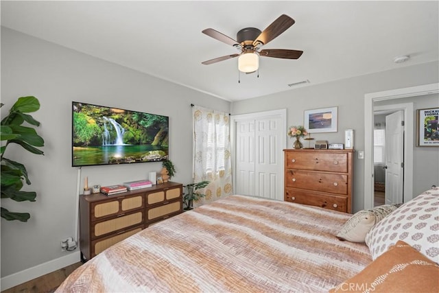 bedroom featuring ceiling fan, hardwood / wood-style flooring, and a closet