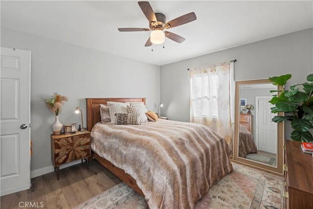 bedroom with ceiling fan and light hardwood / wood-style floors