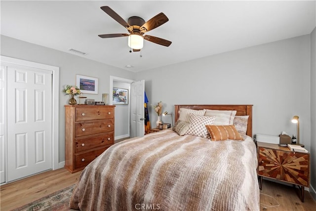 bedroom with light wood-type flooring and ceiling fan