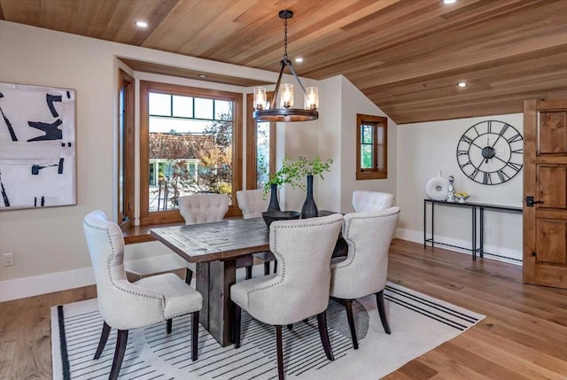 dining space with light hardwood / wood-style flooring, vaulted ceiling, a chandelier, and wooden ceiling