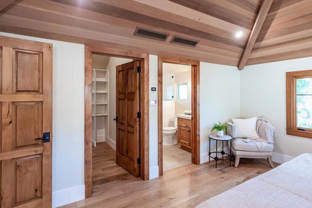 bedroom with light wood-type flooring, ensuite bathroom, wood ceiling, and lofted ceiling with beams