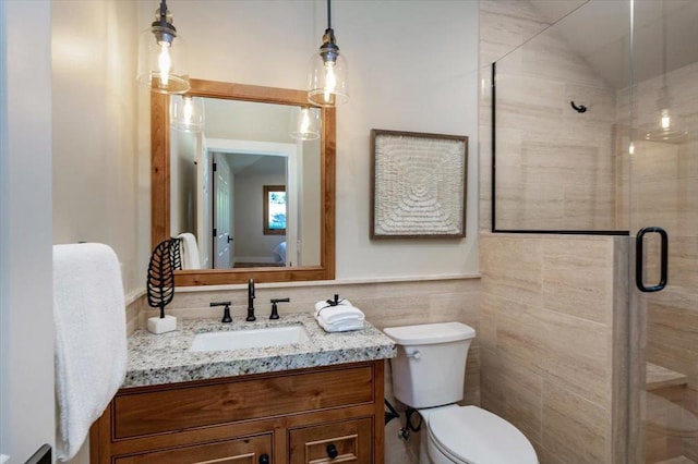 bathroom featuring an enclosed shower, lofted ceiling, vanity, tile walls, and toilet