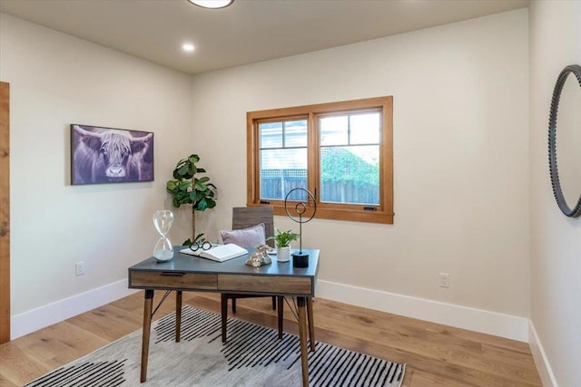 office with light wood-type flooring