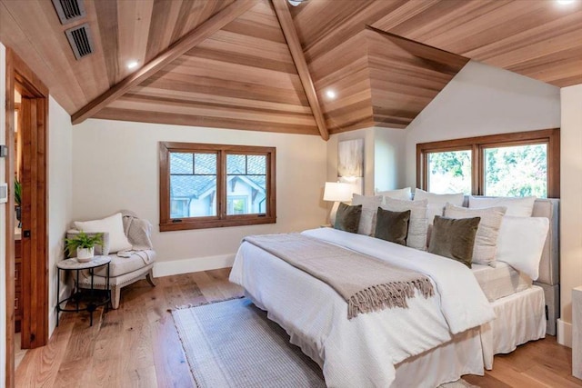 bedroom featuring vaulted ceiling, wood ceiling, and light hardwood / wood-style flooring