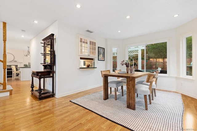 dining room featuring a wealth of natural light and light hardwood / wood-style flooring