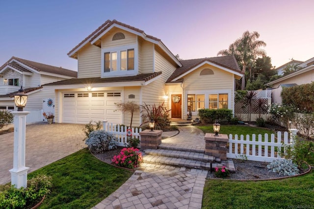 front facade with a lawn and a garage