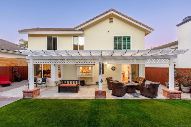 back house at dusk with an outdoor living space, a lawn, and a pergola