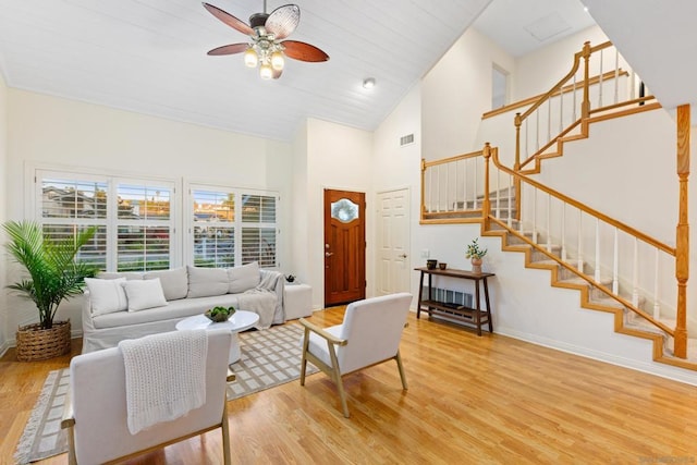 living room featuring plenty of natural light, hardwood / wood-style flooring, and high vaulted ceiling