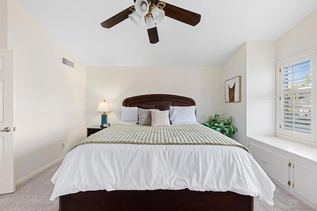 carpeted bedroom with ceiling fan and vaulted ceiling