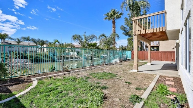 view of yard featuring a water view and a patio area