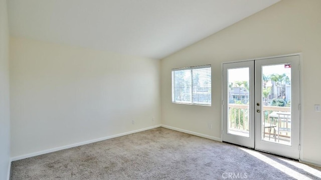 doorway with vaulted ceiling, french doors, and light colored carpet