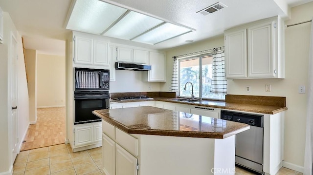 kitchen featuring exhaust hood, black appliances, a center island, sink, and white cabinetry