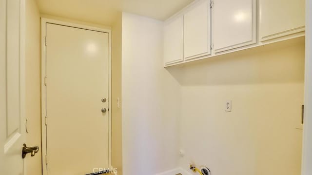 clothes washing area featuring cabinets