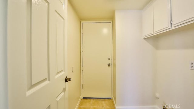 washroom featuring cabinets and light tile patterned flooring