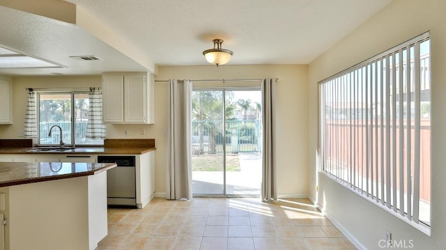 entryway featuring light tile patterned floors and sink