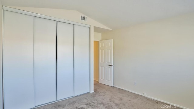 16195 Isla Maria Cir, Moreno Valley, CA 92551 - unfurnished bedroom featuring vaulted ceiling, baseboards, visible vents, light colored carpet, and a closet