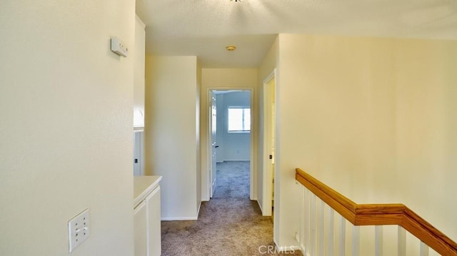 hallway with light colored carpet