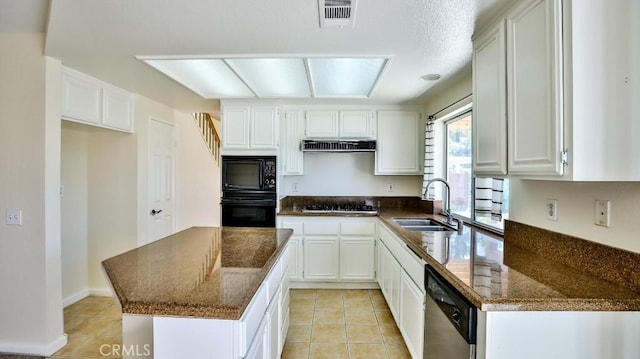 kitchen featuring white cabinetry, black appliances, sink, light tile patterned floors, and dark stone countertops