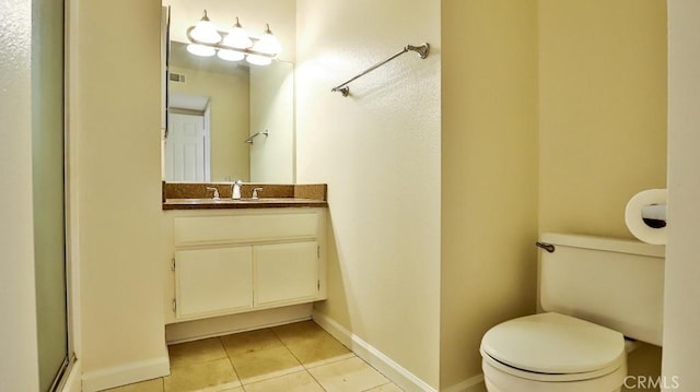 bathroom featuring vanity, toilet, and tile patterned floors