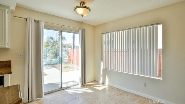 entryway with light tile patterned flooring