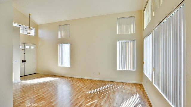 interior space featuring high vaulted ceiling and light hardwood / wood-style floors