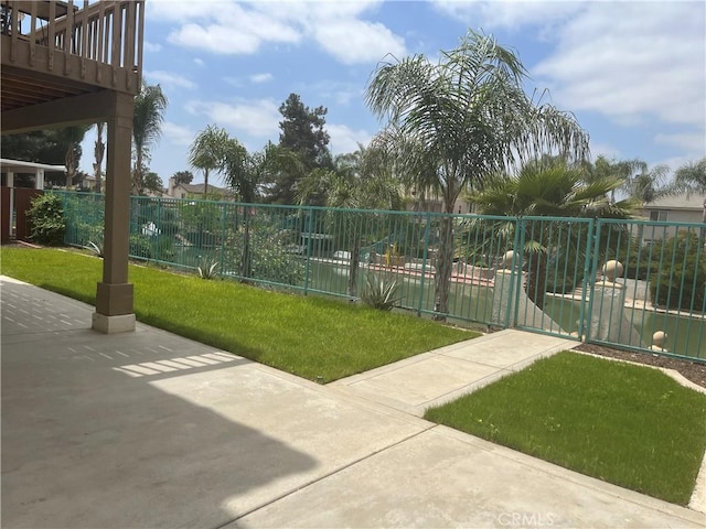 16195 Isla Maria Cir, Moreno Valley, CA 92551 - view of property's community with a lawn, a gate, and fence
