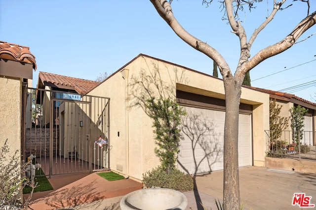 view of side of home featuring a garage