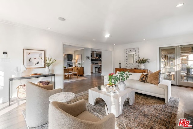 living room with crown molding and hardwood / wood-style flooring