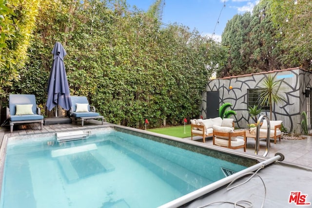 view of swimming pool featuring an outdoor living space and a patio