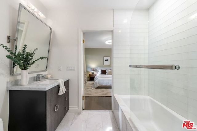 bathroom with tiled tub and vanity