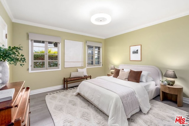 bedroom featuring ornamental molding and hardwood / wood-style floors