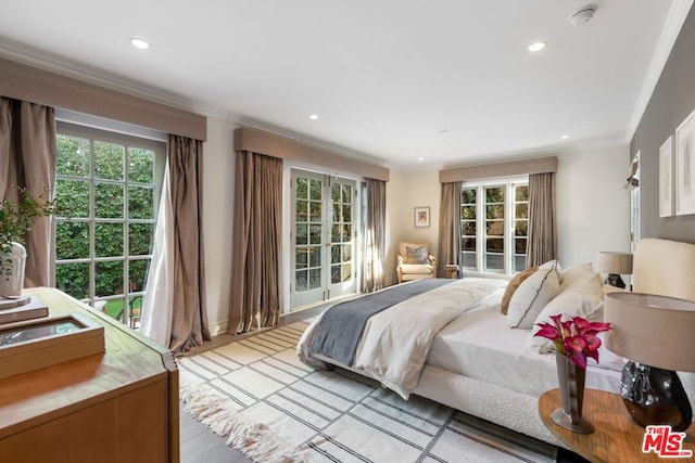 bedroom with light hardwood / wood-style floors and ornamental molding