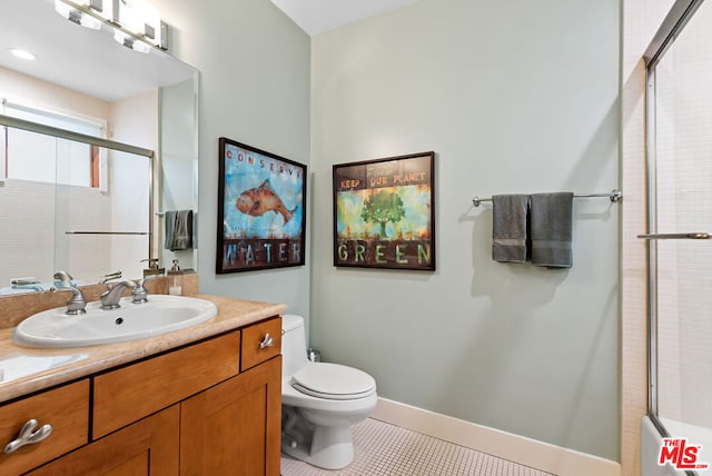 bathroom featuring tile patterned floors, vanity, and toilet