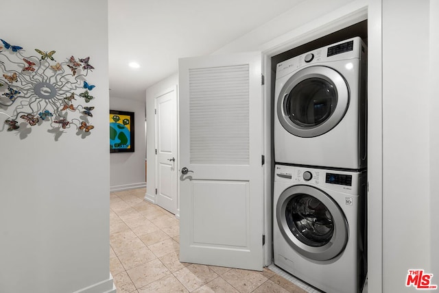 clothes washing area with stacked washer / dryer and light tile patterned floors