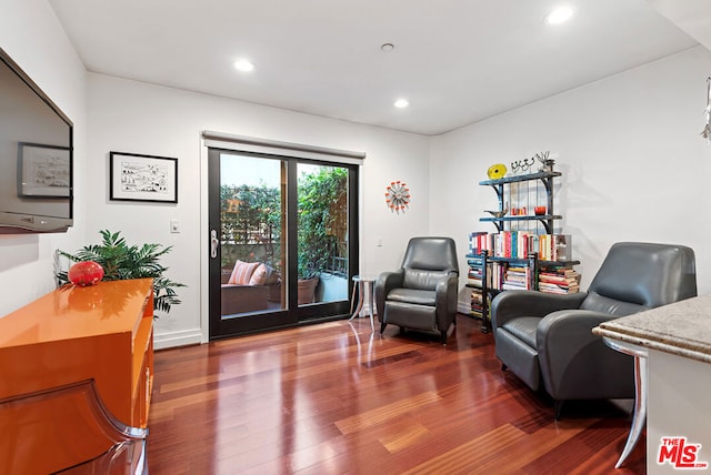 living area with hardwood / wood-style floors