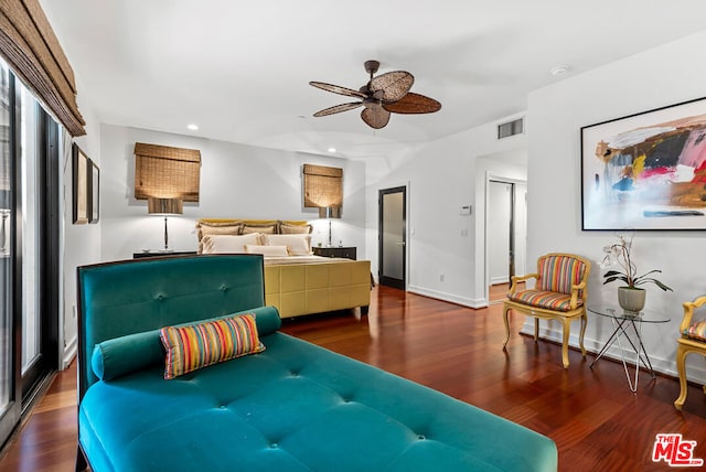 living room featuring ceiling fan and hardwood / wood-style floors