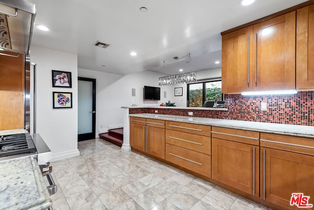 kitchen with decorative backsplash and light stone counters