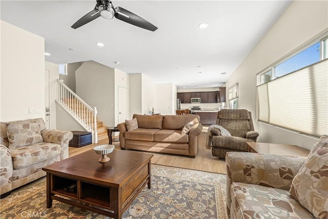 living room featuring ceiling fan and hardwood / wood-style floors