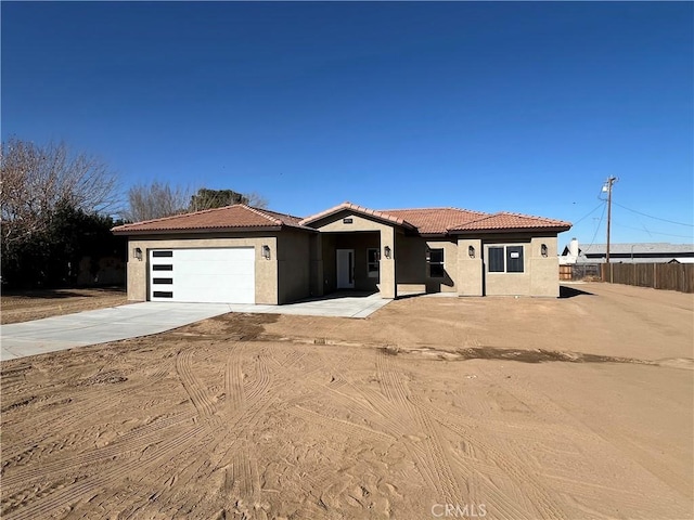 mediterranean / spanish-style home with a garage