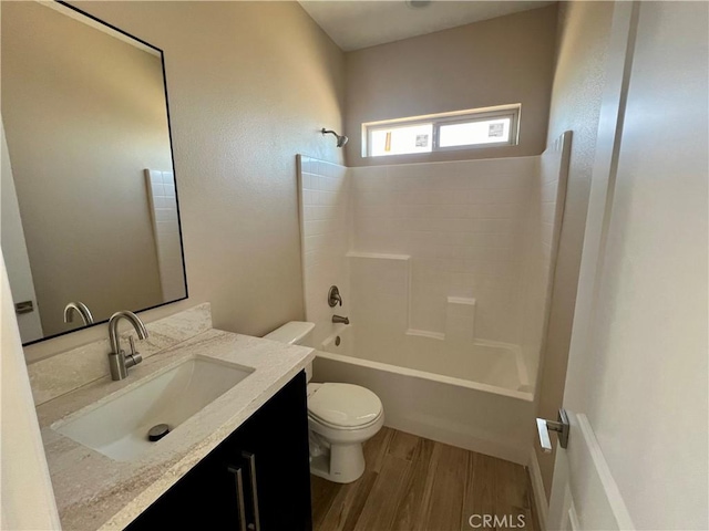 full bathroom with toilet, hardwood / wood-style flooring, shower / washtub combination, and vanity