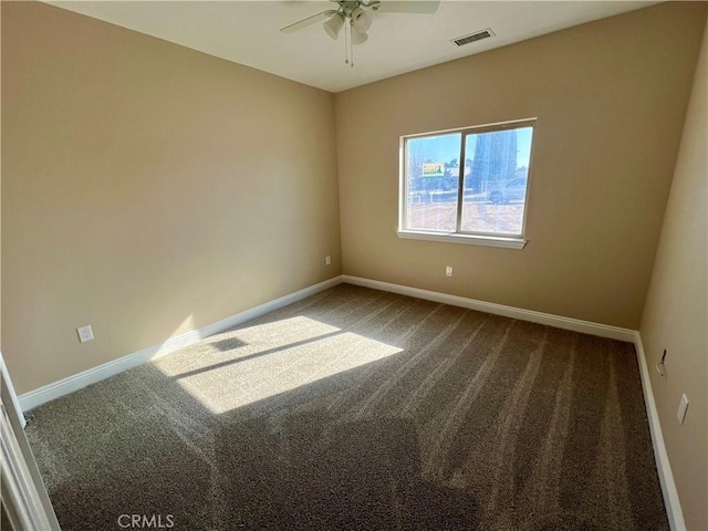 carpeted spare room with ceiling fan