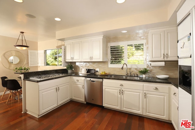 kitchen featuring pendant lighting, white cabinetry, dark hardwood / wood-style flooring, sink, and stainless steel dishwasher