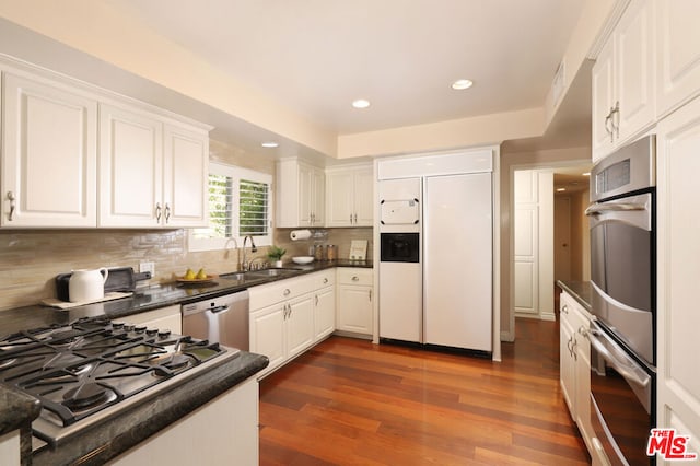 kitchen featuring white cabinetry, stainless steel appliances, dark hardwood / wood-style flooring, and sink