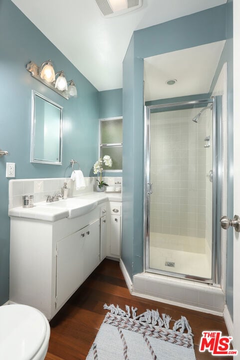 bathroom featuring vanity, hardwood / wood-style floors, and walk in shower