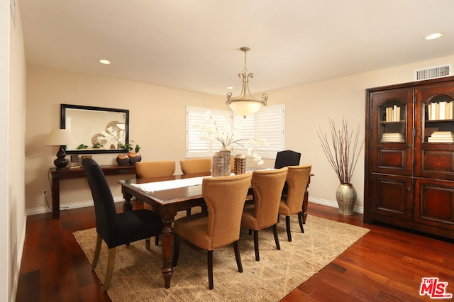 dining space with dark hardwood / wood-style floors