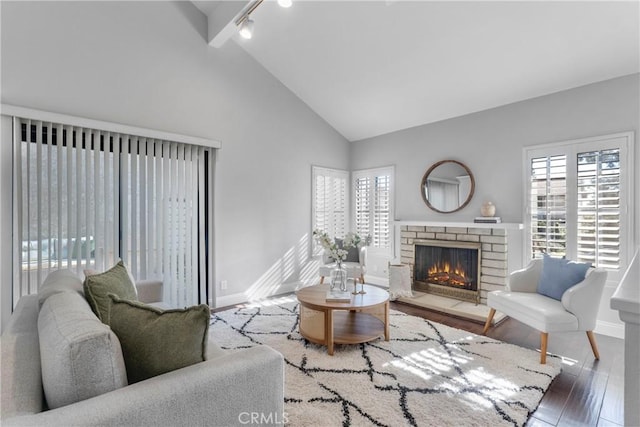 living room with high vaulted ceiling, wood-type flooring, and beamed ceiling